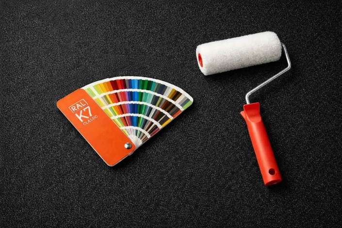 error-elegir-pintura-carta-RAL Error al elegir el color de la pintura a través de carta RAL, mostrando una carta RAL K7 y un rodillo de pintor sobre fondo oscuro.